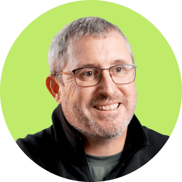 Profile picture of Patrick Mee, showing a person with a pleasant expression, framed within a green circular border.